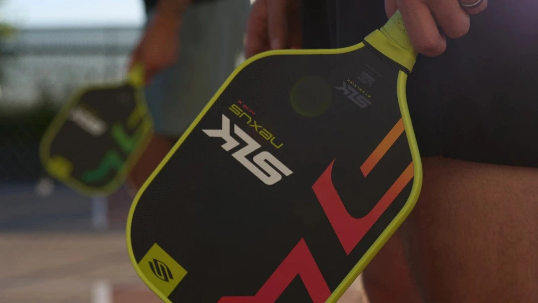 Pickleball player holds Selkirk SLK paddle