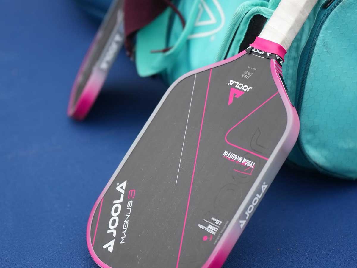 Man holds pickleball paddle uk over a net